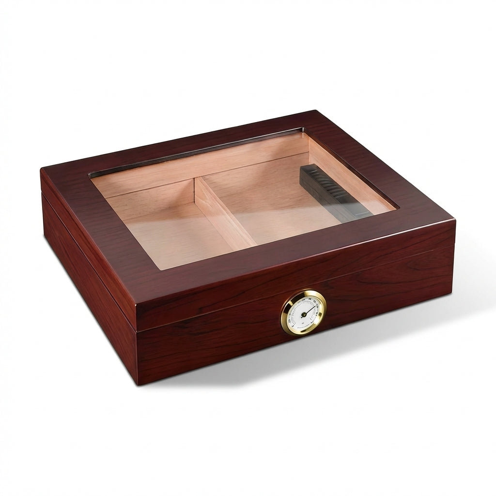 Angled perspective of a closed Spanish cedar humidor with a tempered glass top and cherry wood finish. Showcases the external gold hygrometer and internal cedar dividers through the glass.