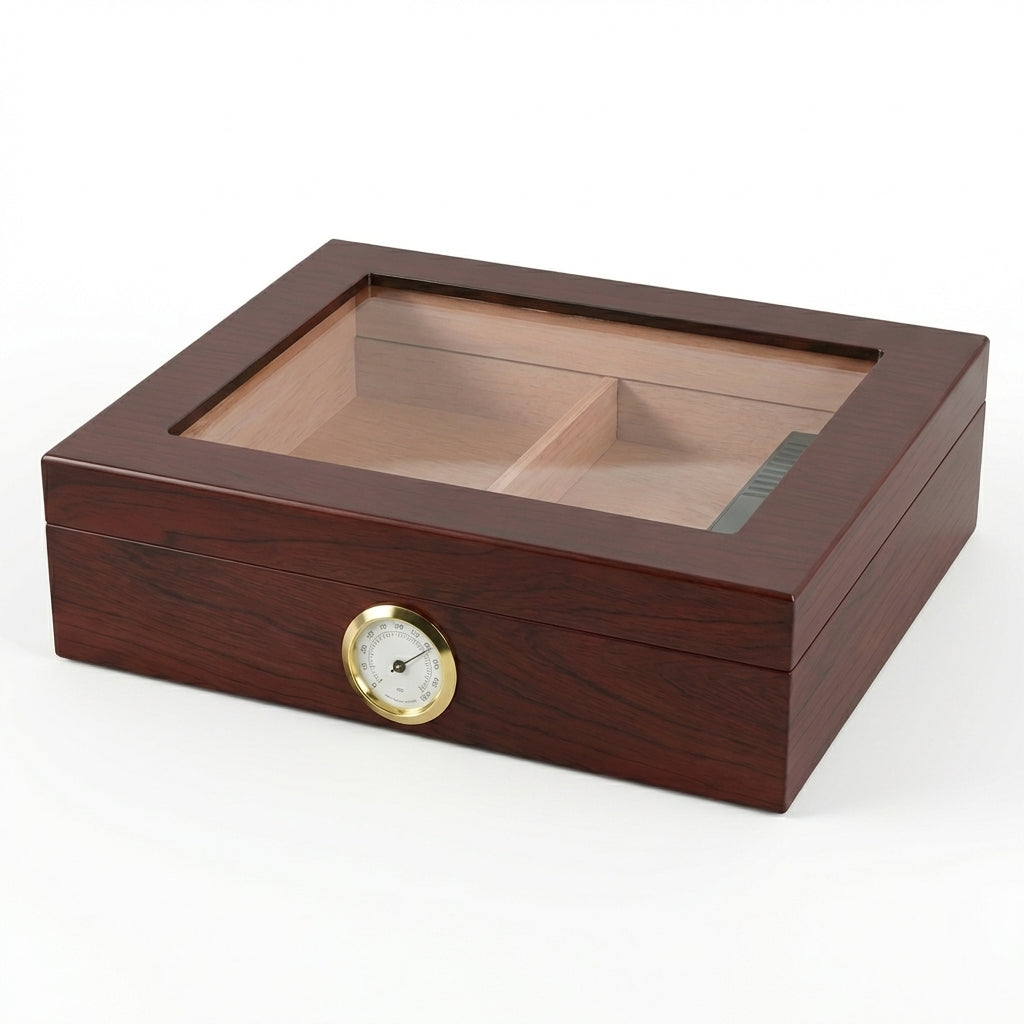 Closed glass-top cigar humidor with a rich cherry wood finish and a large front-facing gold analog hygrometer. Hand-polished wood grain texture visible on a white background.