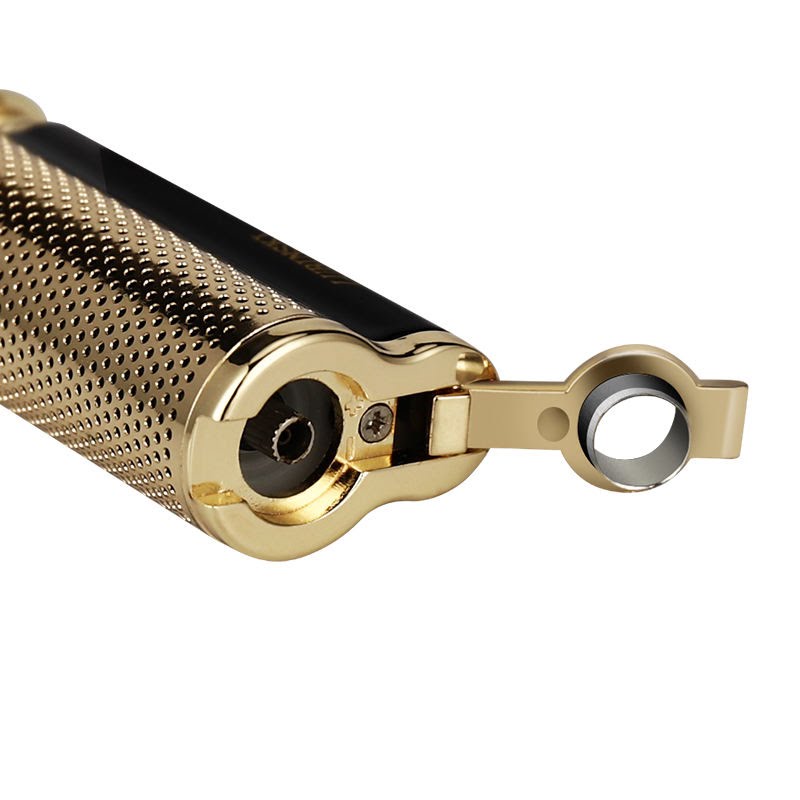 Close-up of a luxury gold cigar lighter featuring a textured studded grip and an integrated circular punch cutter flipped open to reveal the sharp steel blade. High-end product shot on a white background.