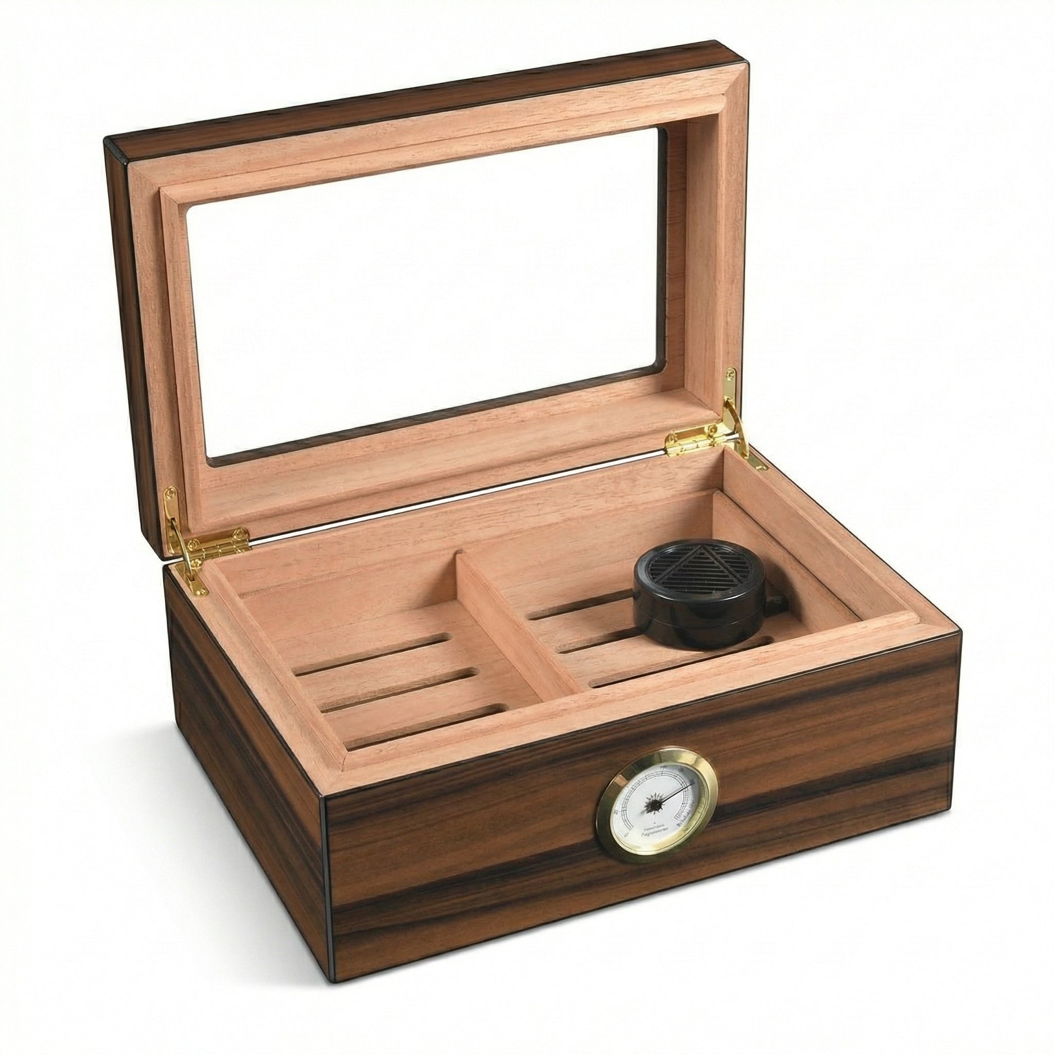 Close-up of the interior lid of a Spanish cedar-lined cigar humidor. Features a gold-rimmed analog hygrometer and a black circular humidifier disc mounted to the wood surface.