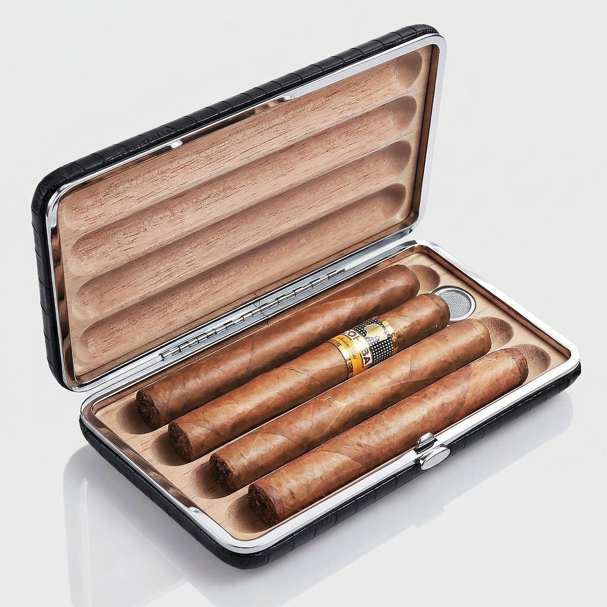 Open black crocodile-embossed leather travel cigar humidor with silver metal trim, cedar-lined interior holding 4 premium cigars in individual grooves, with a built-in humidifier bar