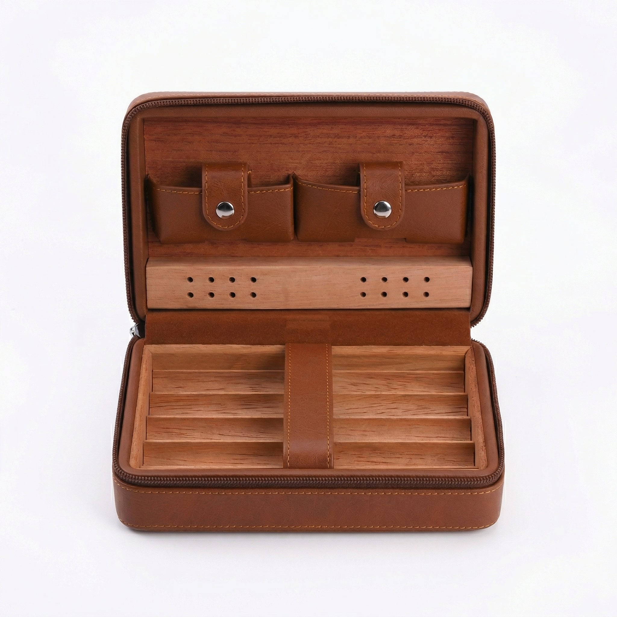 Open view of a portable leather-wrapped travel cigar humidor, in a warm brown tone. The interior features Spanish cedar lining with a removable five-cigar tray, a central leather strap, a perforated humidification bar, and two leather pouches for accessories (lighter and cutter) with button snaps. The entire case has a zippered closure